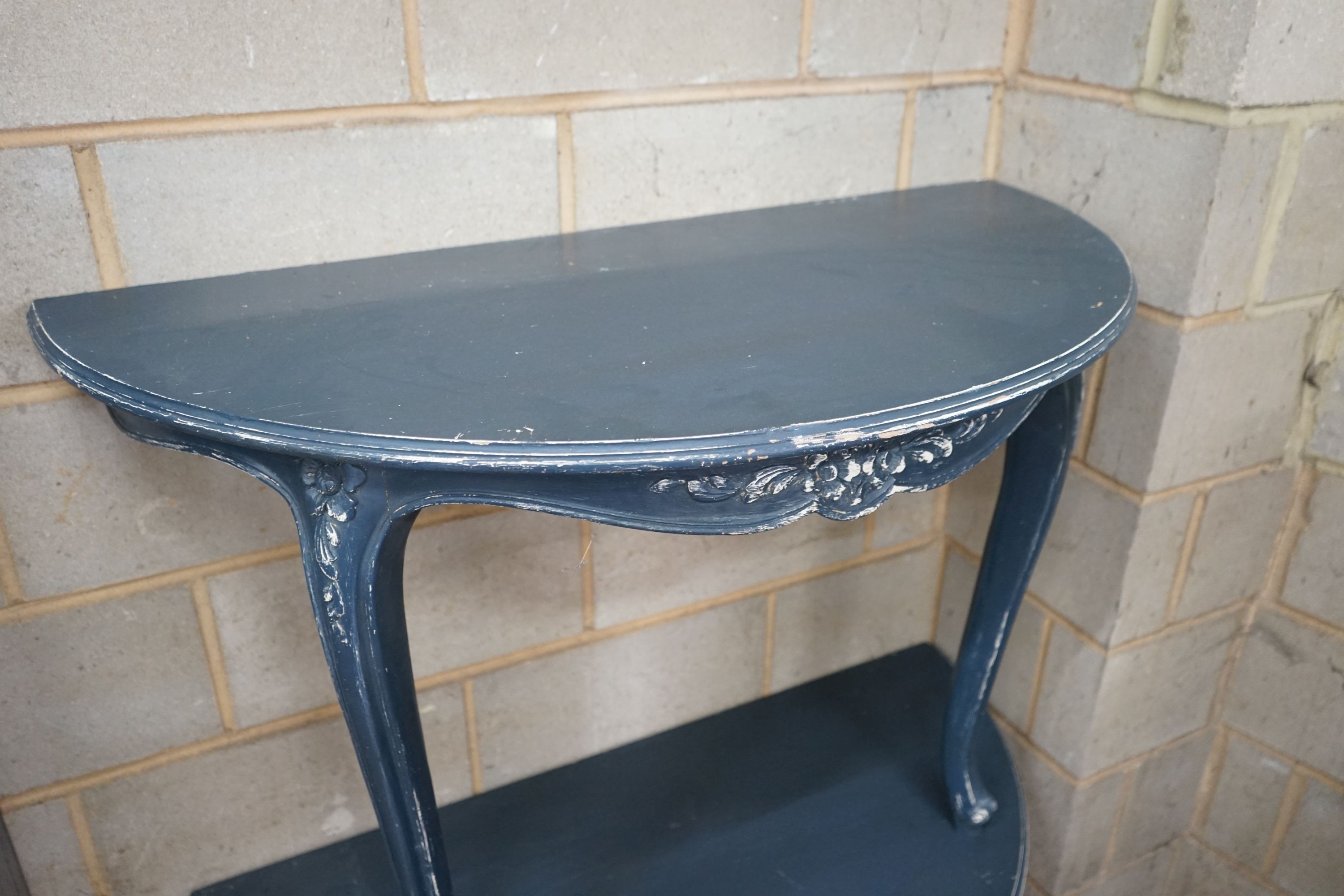 A pair of Louis XVI style painted demi lune console tables, width 112cm, depth 56cm, height 75cm